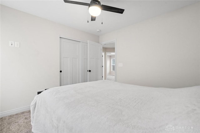 bedroom with light carpet, a closet, and ceiling fan