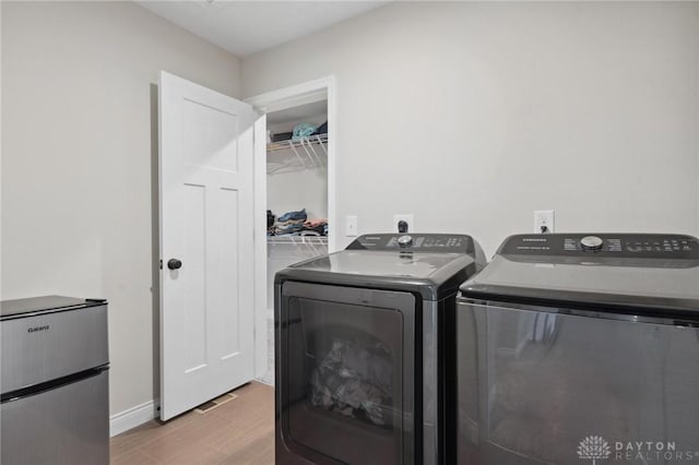 clothes washing area with independent washer and dryer