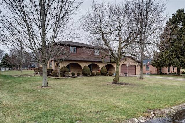 view of front of home with a garage and a front yard