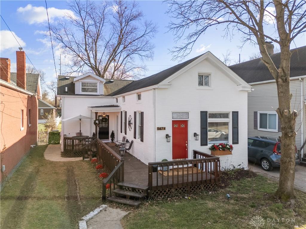 back of house featuring a lawn and a deck