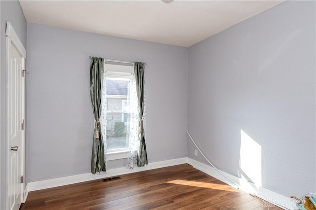 unfurnished room featuring dark hardwood / wood-style flooring