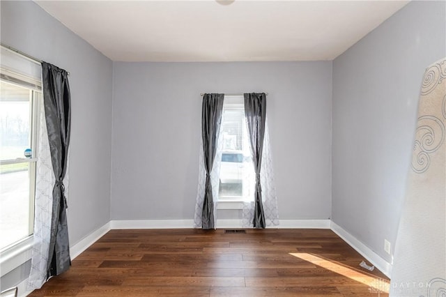 unfurnished room with dark hardwood / wood-style floors