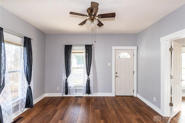 entryway with dark hardwood / wood-style floors and ceiling fan