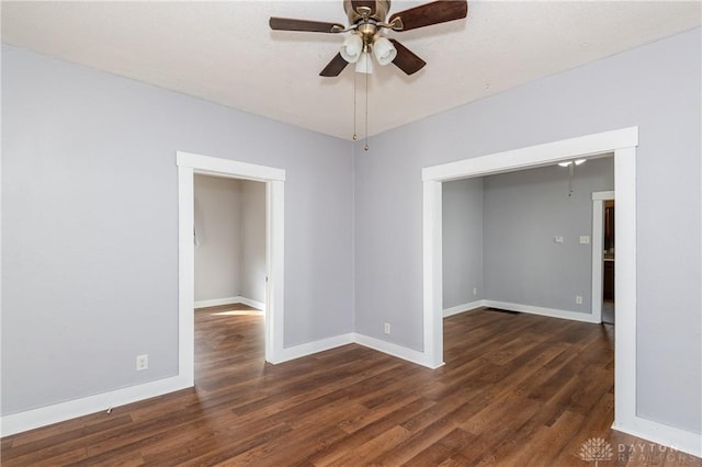 empty room featuring dark hardwood / wood-style floors and ceiling fan