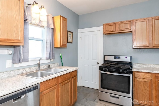 kitchen featuring sink, light tile patterned floors, and appliances with stainless steel finishes