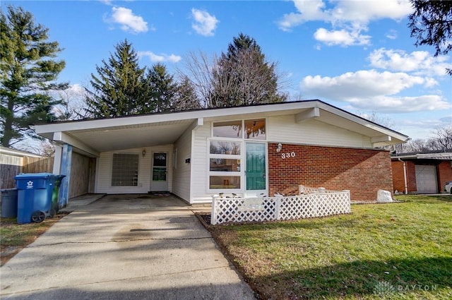 view of front facade with a front yard and a carport