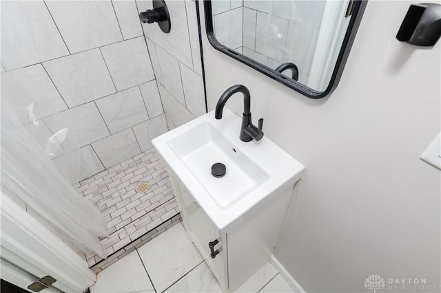 bathroom with tile patterned flooring, curtained shower, and sink