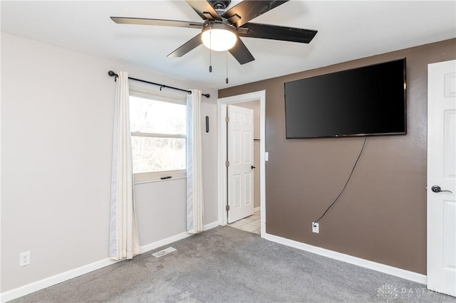 spare room with light carpet and ceiling fan