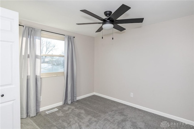 carpeted spare room with ceiling fan