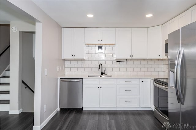 kitchen with white cabinets, stainless steel appliances, dark wood-type flooring, and sink