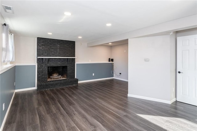 unfurnished living room featuring dark hardwood / wood-style flooring and a fireplace