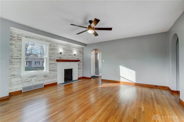 unfurnished living room with ceiling fan and light hardwood / wood-style floors