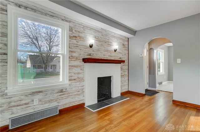 unfurnished living room featuring hardwood / wood-style floors and a fireplace