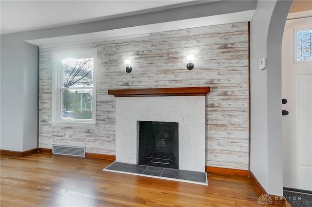 room details featuring wood-type flooring and a brick fireplace