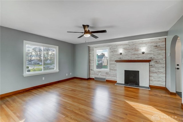 unfurnished living room featuring ceiling fan and hardwood / wood-style floors