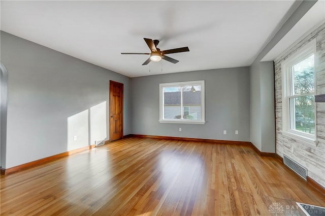 empty room featuring ceiling fan and light wood-type flooring