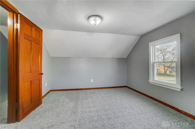 bonus room featuring light colored carpet and lofted ceiling