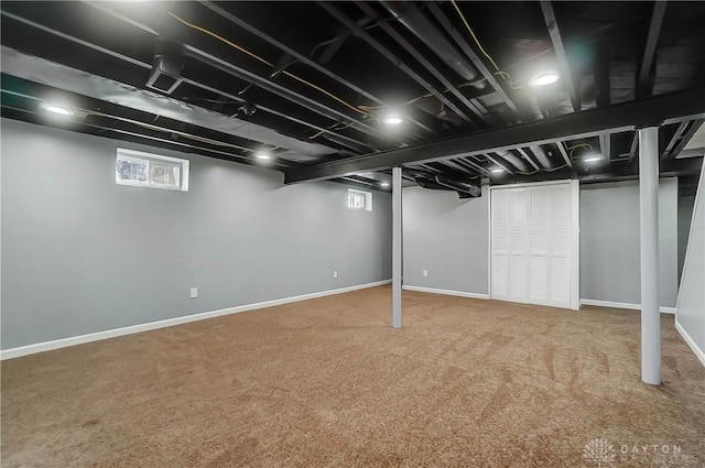 basement featuring carpet flooring and a wealth of natural light