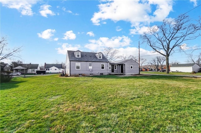 rear view of property featuring a lawn