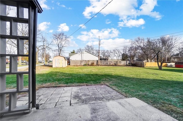 view of yard with a shed and a patio area