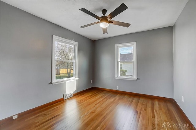 empty room featuring light wood-type flooring and ceiling fan