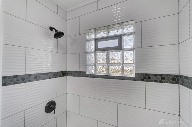 bathroom with tiled shower