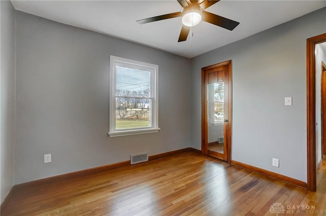 unfurnished room featuring ceiling fan, a healthy amount of sunlight, and light hardwood / wood-style floors