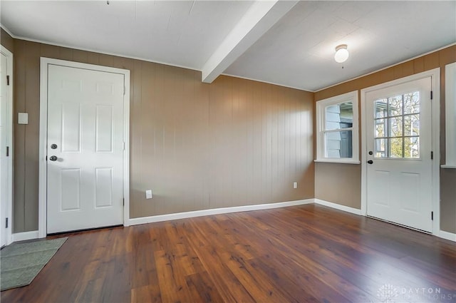 entryway with beam ceiling and dark hardwood / wood-style flooring