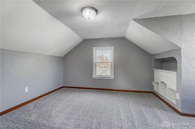 bonus room featuring carpet flooring and lofted ceiling