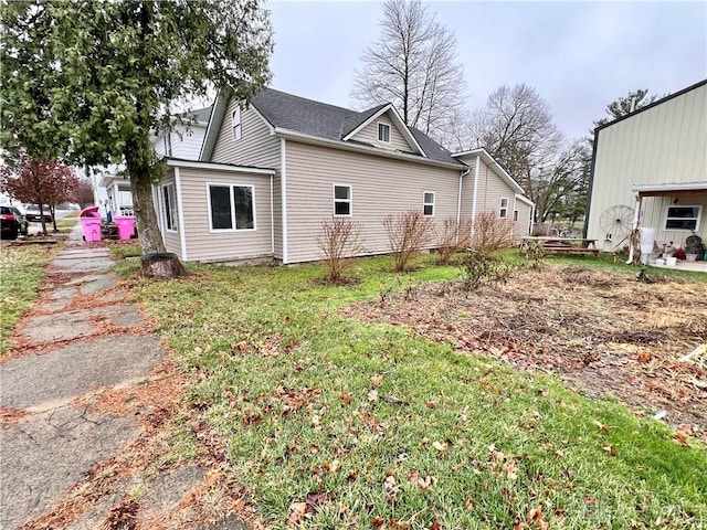 view of side of home featuring a lawn