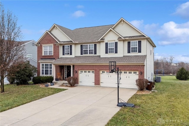 view of front of property with a garage, a front yard, and central AC