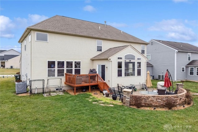 back of property featuring a lawn, a patio, a wooden deck, and central AC