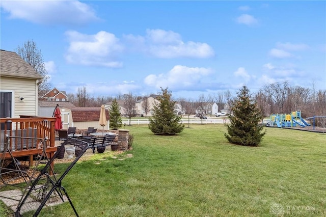 view of yard with a playground and a shed