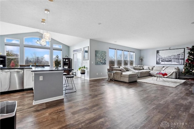 living room featuring vaulted ceiling, a chandelier, and dark hardwood / wood-style floors