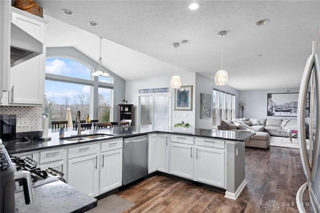 kitchen with white cabinets, sink, decorative backsplash, kitchen peninsula, and stainless steel appliances