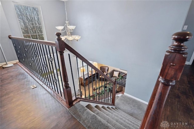 staircase with an inviting chandelier