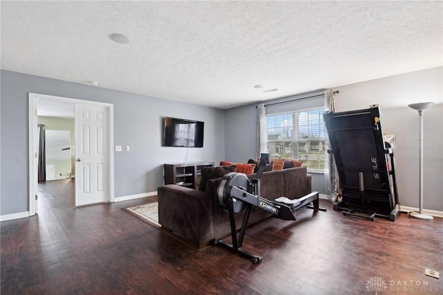 living room with dark hardwood / wood-style flooring and a textured ceiling