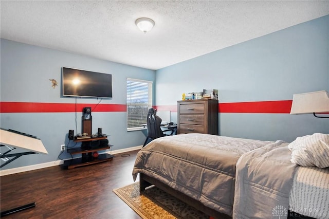 bedroom featuring a textured ceiling and dark wood-type flooring