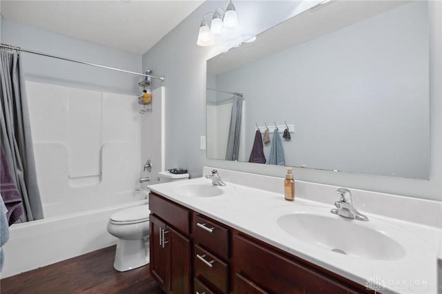 full bathroom with shower / bath combo, vanity, hardwood / wood-style flooring, and toilet