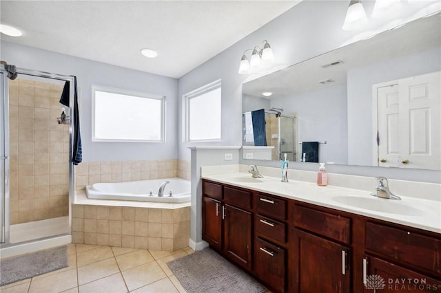 bathroom with vanity, tile patterned flooring, and plus walk in shower