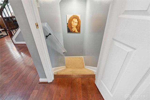 stairs featuring hardwood / wood-style floors