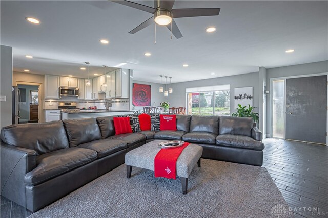 living room with wood-type flooring and ceiling fan