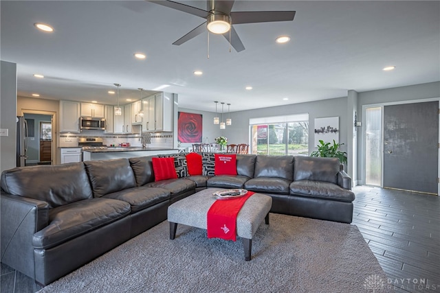 living room featuring ceiling fan, wood finished floors, and recessed lighting