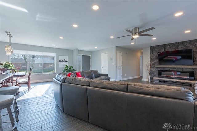 living area featuring ceiling fan, baseboards, wood finished floors, and recessed lighting