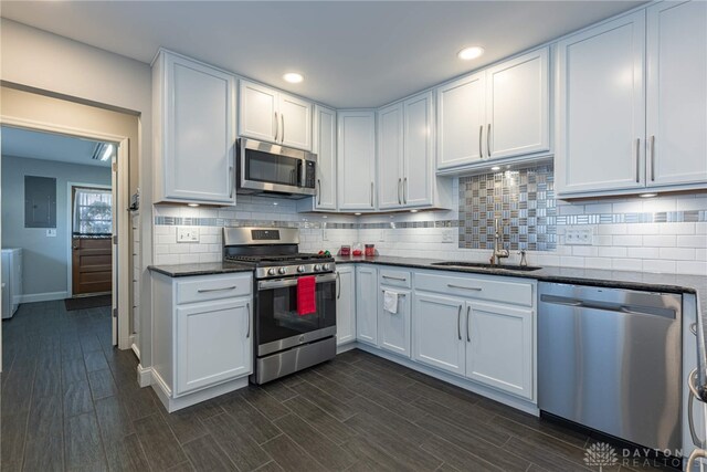 kitchen featuring appliances with stainless steel finishes, wood finish floors, and a sink