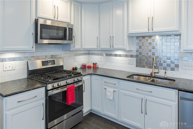 kitchen with white cabinetry, appliances with stainless steel finishes, and a sink