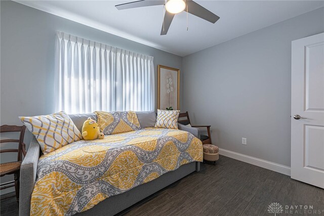 bedroom with ceiling fan, baseboards, and dark wood-style flooring