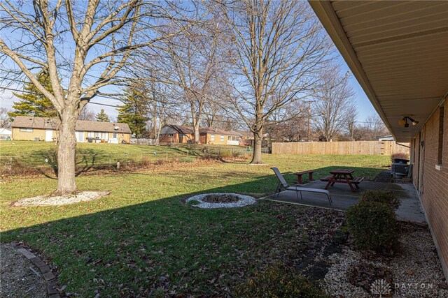 view of yard featuring fence and a patio