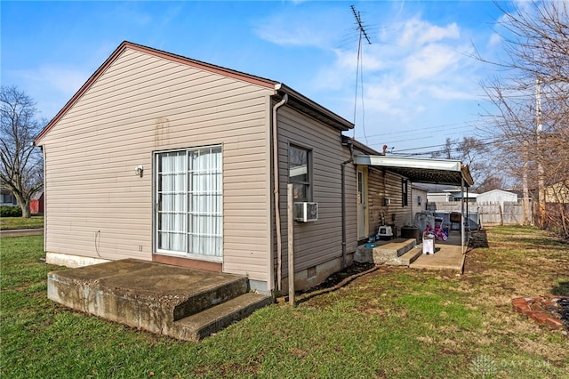 view of property exterior featuring a lawn, cooling unit, and a patio