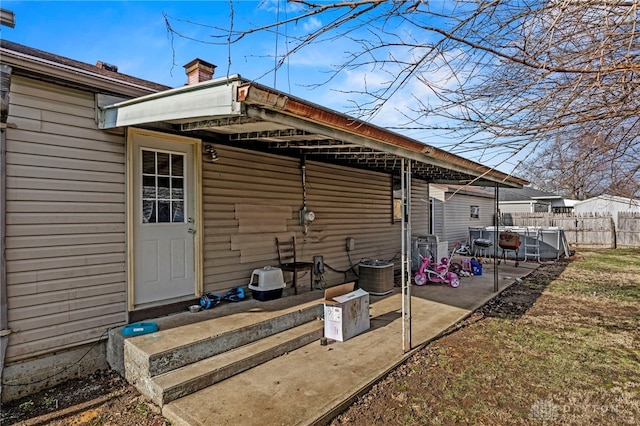 back of property with central air condition unit and a patio area